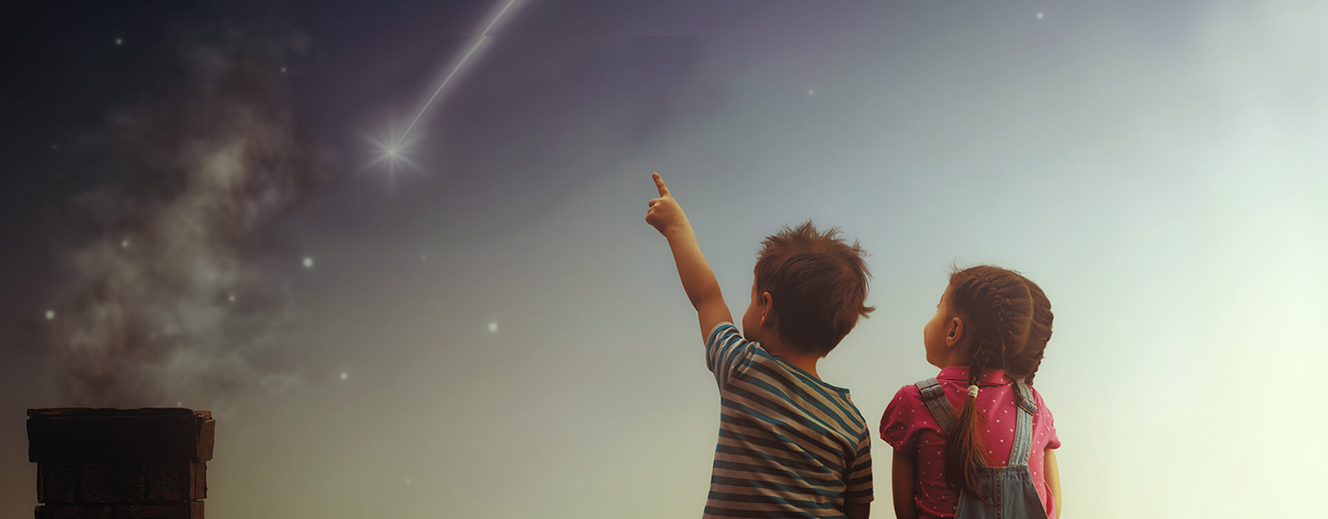Two small kids gazing at the sky